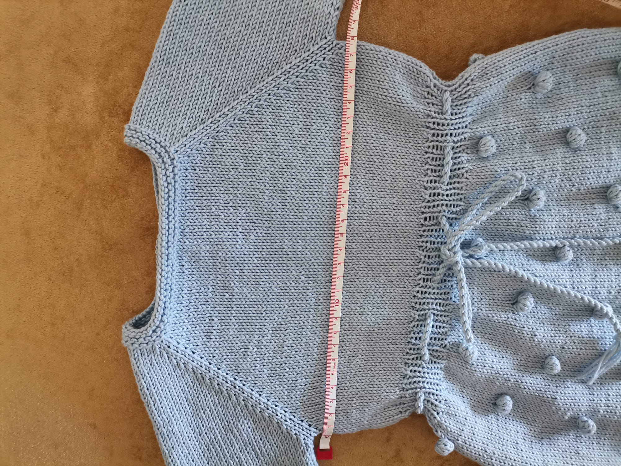 Mavi ponpon desenli bebek yeleği bağlamalı el örgüsü